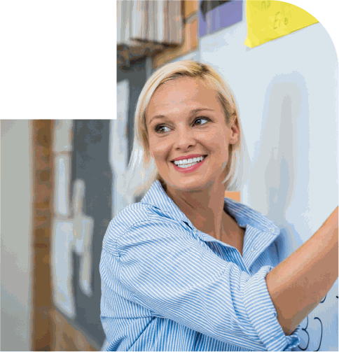 Smiling Teacher at the Whiteboard
